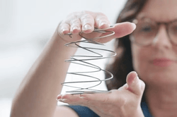 A woman holding an IntelliCoil between her hands