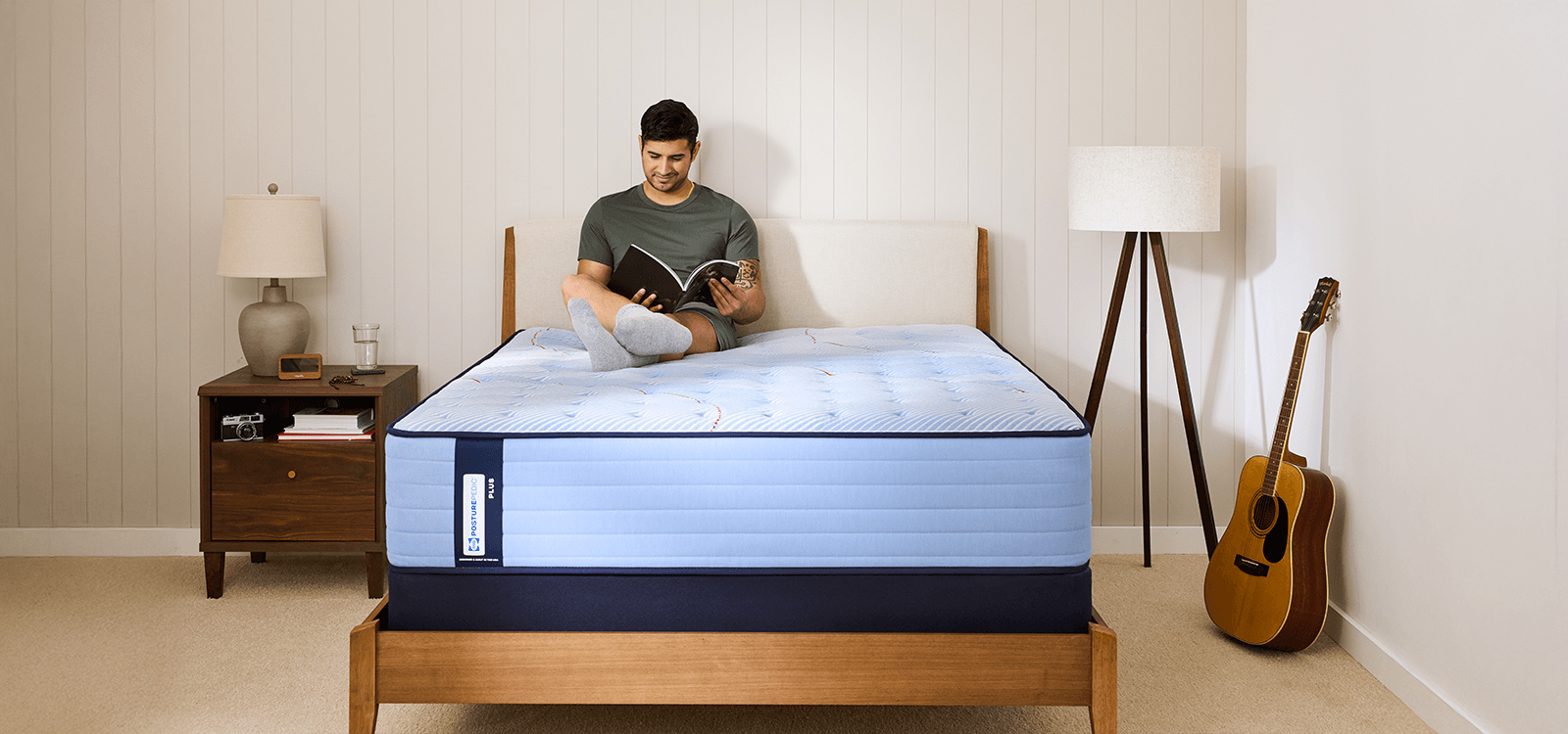 Man lounging on a Posturepedic Plus Spring Tight Top mattress