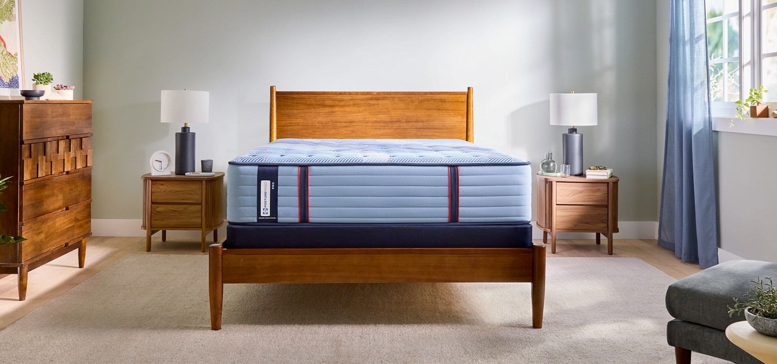 Posturepedic Pro Spring Tight Top mattress on a bedframe in a styled room