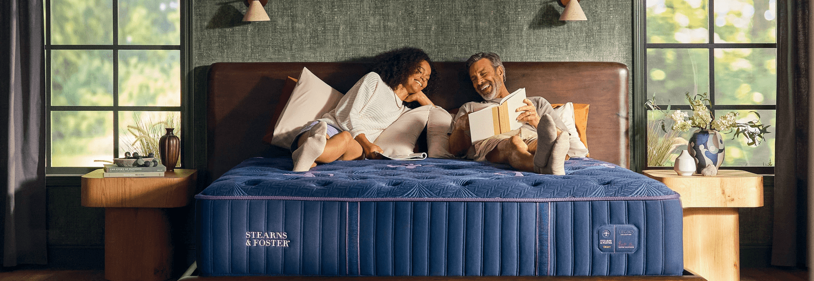 Couple laying on a Stearns & Foster Legacy King Tight Top Medium Mattress in a styled room